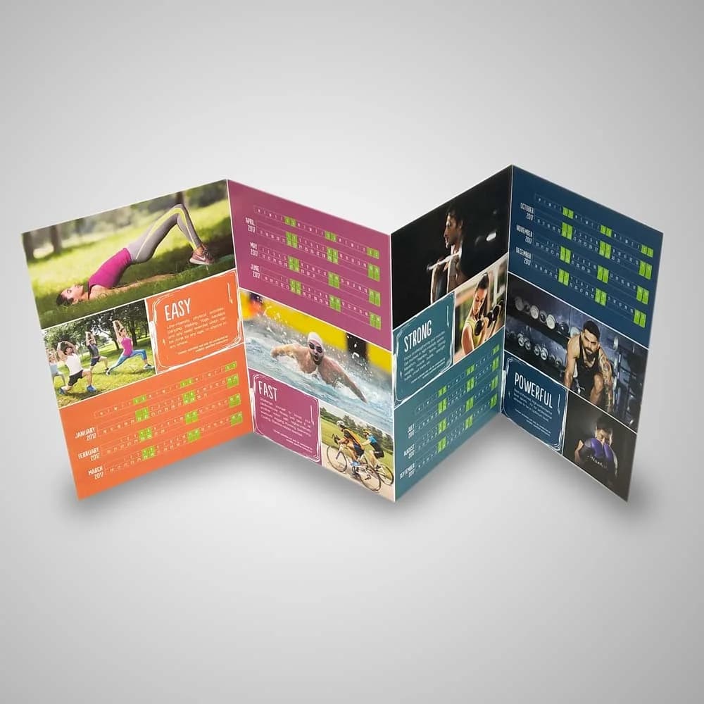 Concertina-folded wall calendar standing open across twelve panels